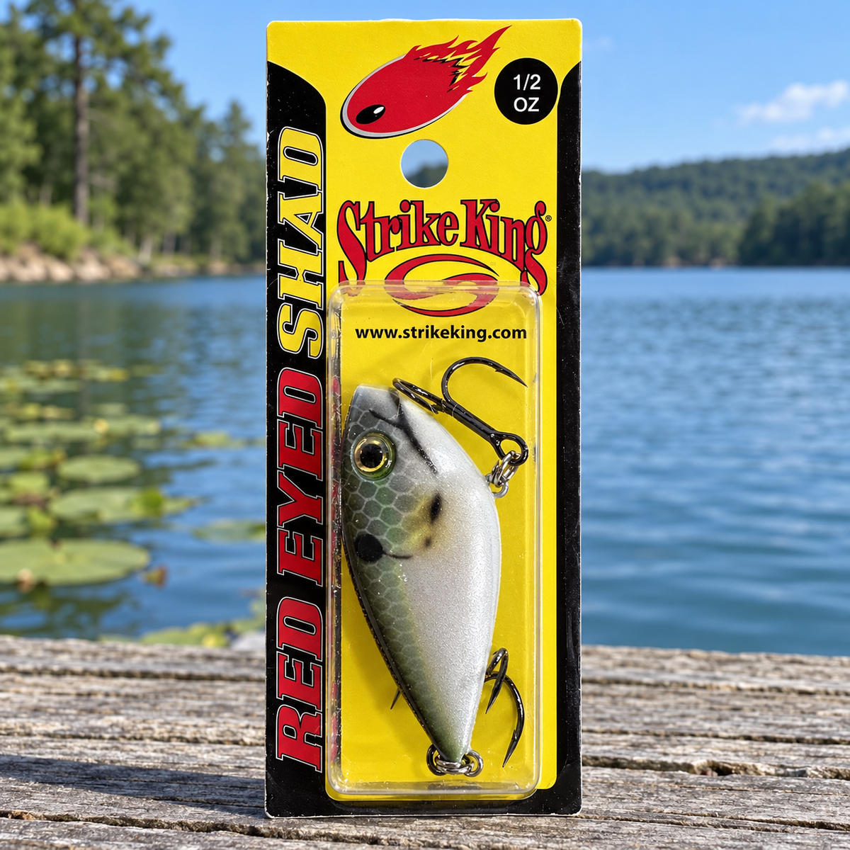 Strike King Red Eyed Shad 1/2 oz in Reel Shad — full retail package on a dock (Oscar hero)