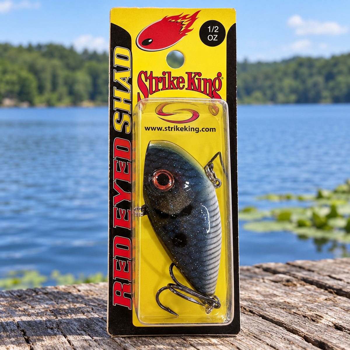 Strike King Red Eyed Shad 1/2 oz Bleu Shad - full retail package on dock by lake